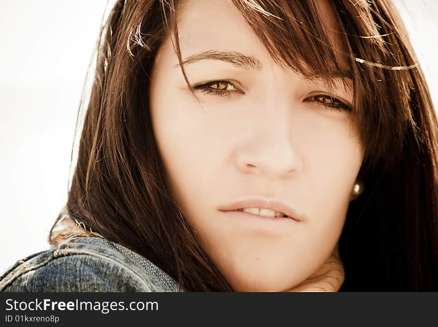 Young woman staring at camera under sunlight. Young woman staring at camera under sunlight