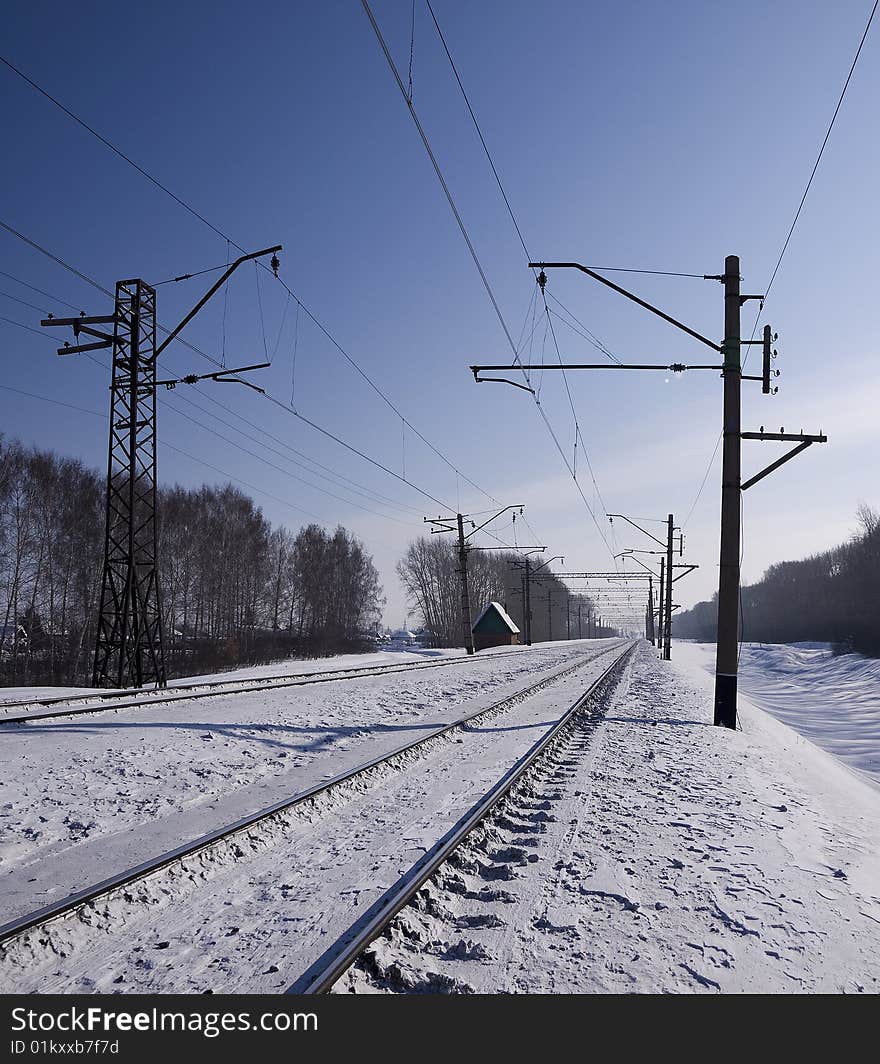 The railway leaving far, is accompanied by lines of electrotransfers