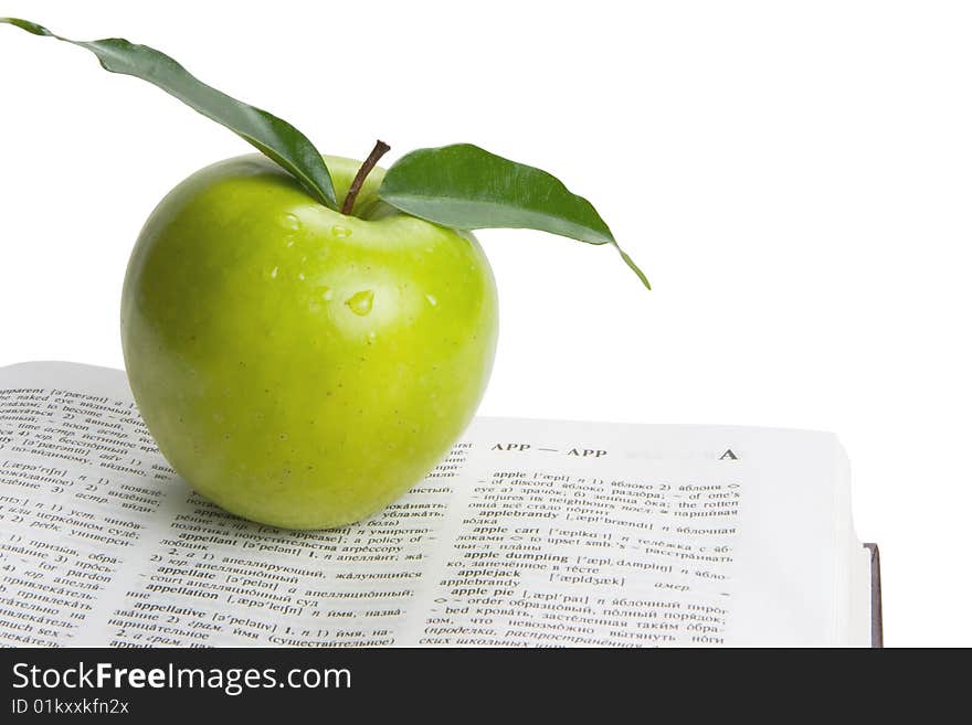 Book and green apple. White background. Book and green apple. White background