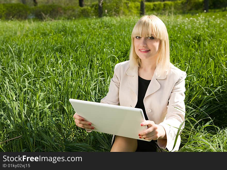 Girl with a laptop outdoors. Girl with a laptop outdoors