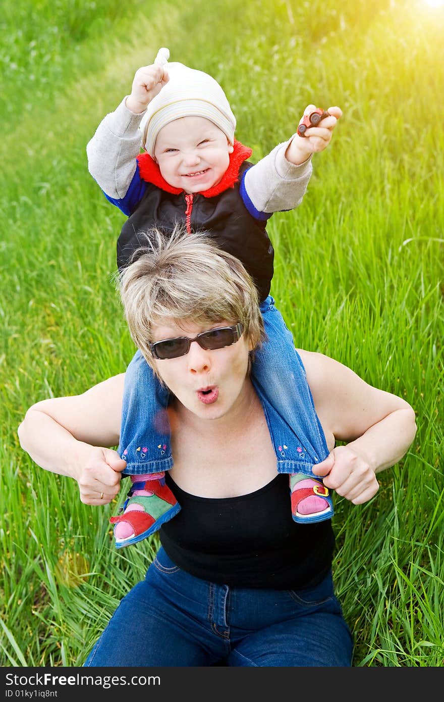 Small girl on the grass with grandmother. Small girl on the grass with grandmother