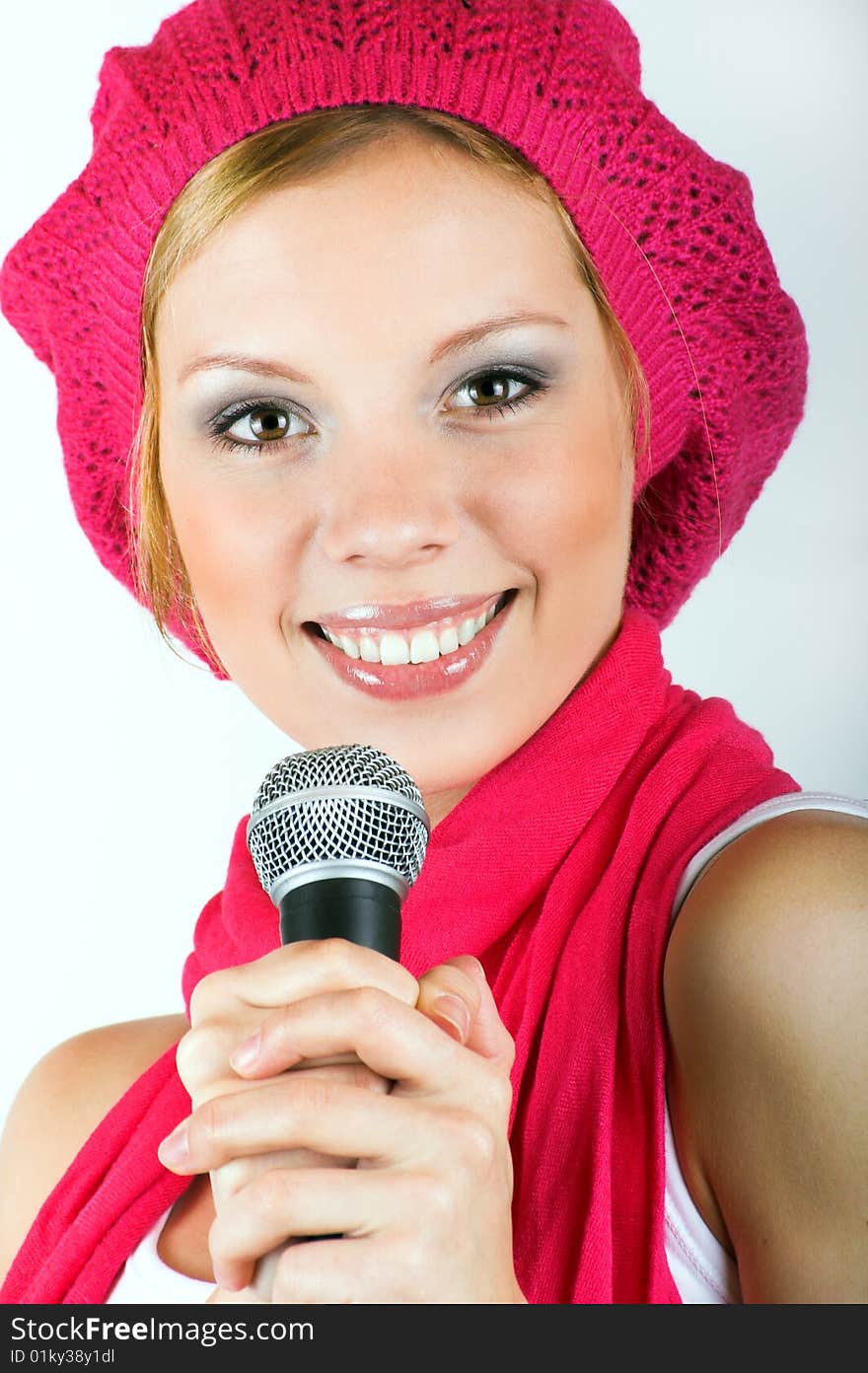 Portrait of a happy singing woman with a microphone. Portrait of a happy singing woman with a microphone