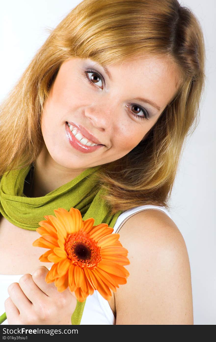 Beauty portrait of a smiling woman with a flower