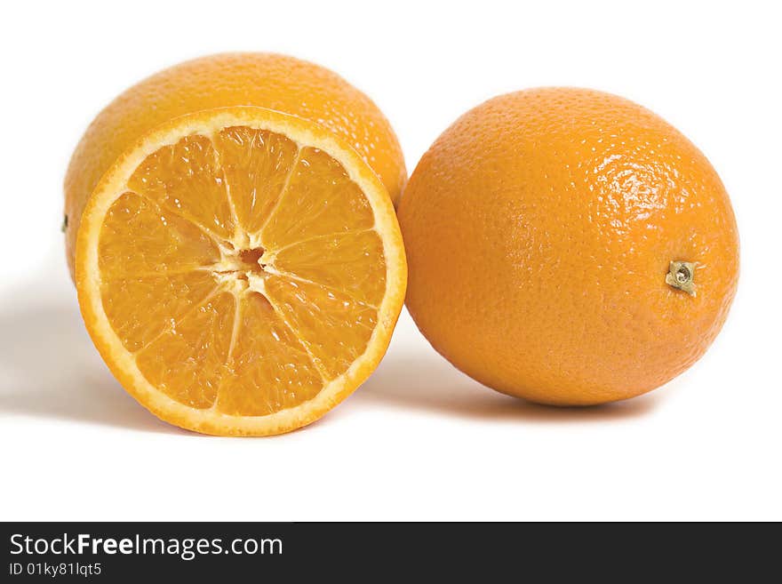 Two citrus orange fruits and a slice of orange isolated on white background. Two citrus orange fruits and a slice of orange isolated on white background