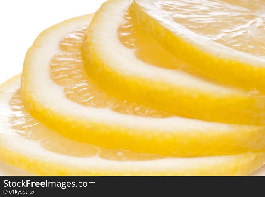 A horizontal macro of juicy fresh cut lemon slices.