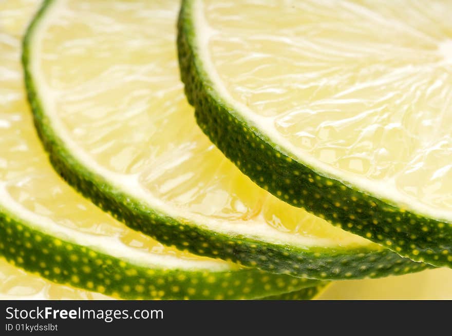 A macro of a stack of fresh cut lime slices.