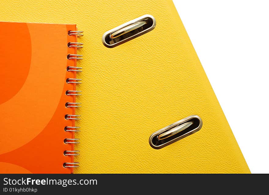 Yellow binder, orange agenda over white. Yellow binder, orange agenda over white