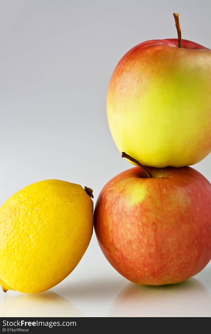 Lemon and apples on neutral background