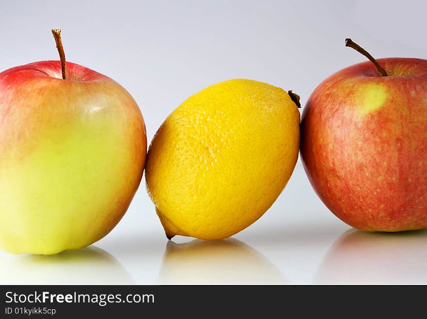 Lemon and apples on neutral background