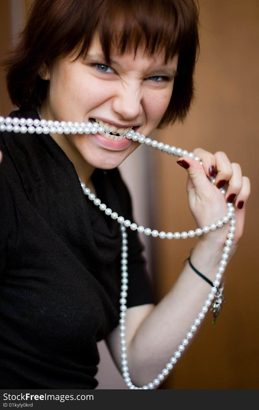 Beautiful girl with beads in her teeth. Beautiful girl with beads in her teeth