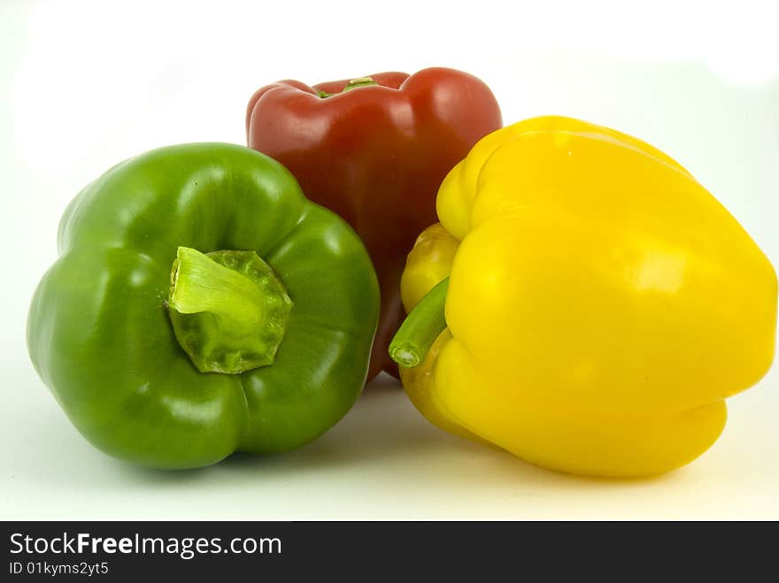 Yellow and green and red bell peppers isolated on white background. Yellow and green and red bell peppers isolated on white background