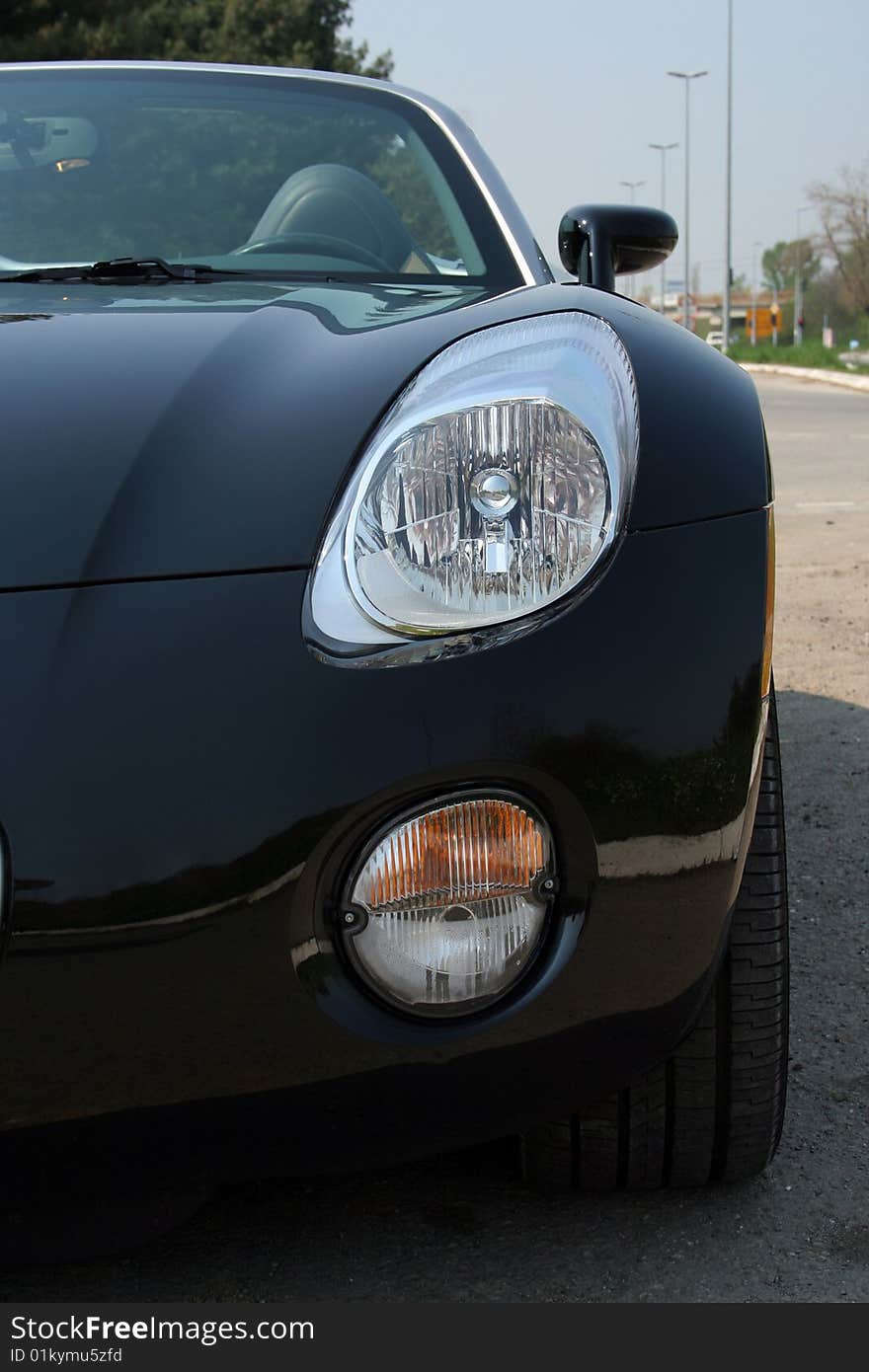 Black roadster parked on the road. Black roadster parked on the road