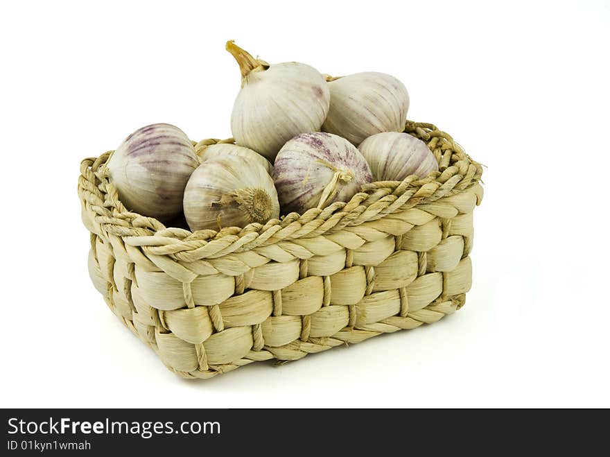 Basket full of fresh garlics isolated on white background