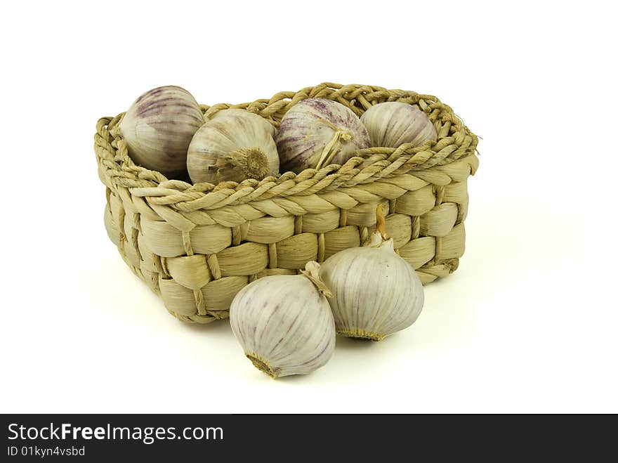 Basket full of fresh garlics isolated on white background