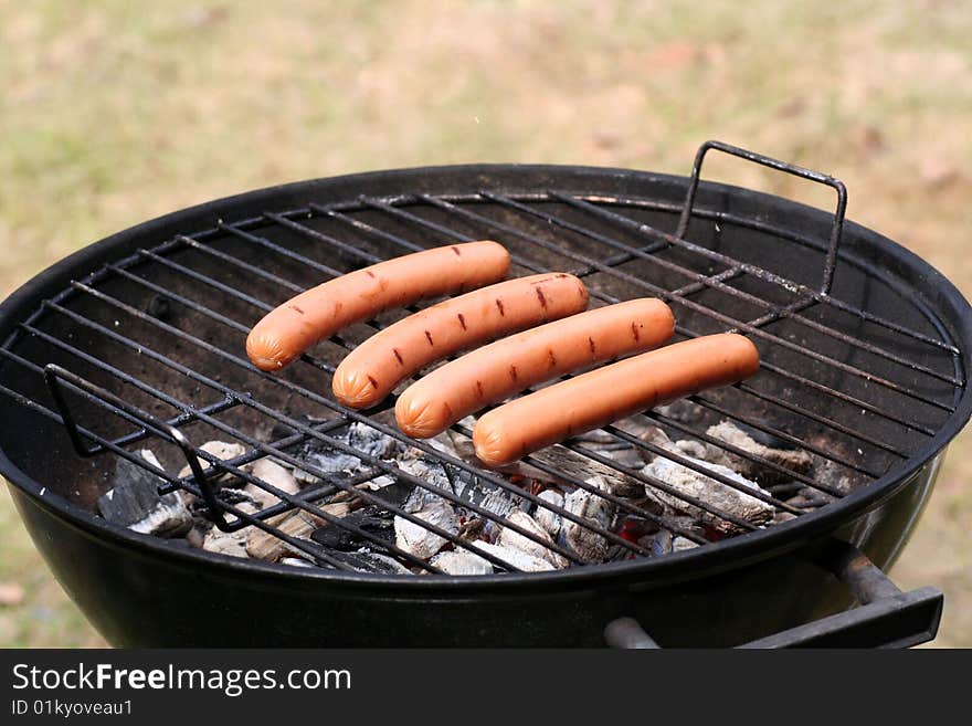 The first grilling for the season. Spring grilling of hot dogs