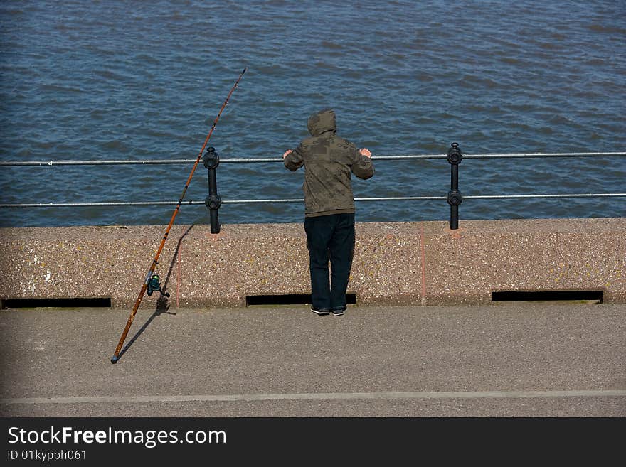 Picture of a fisherman with fishing rod