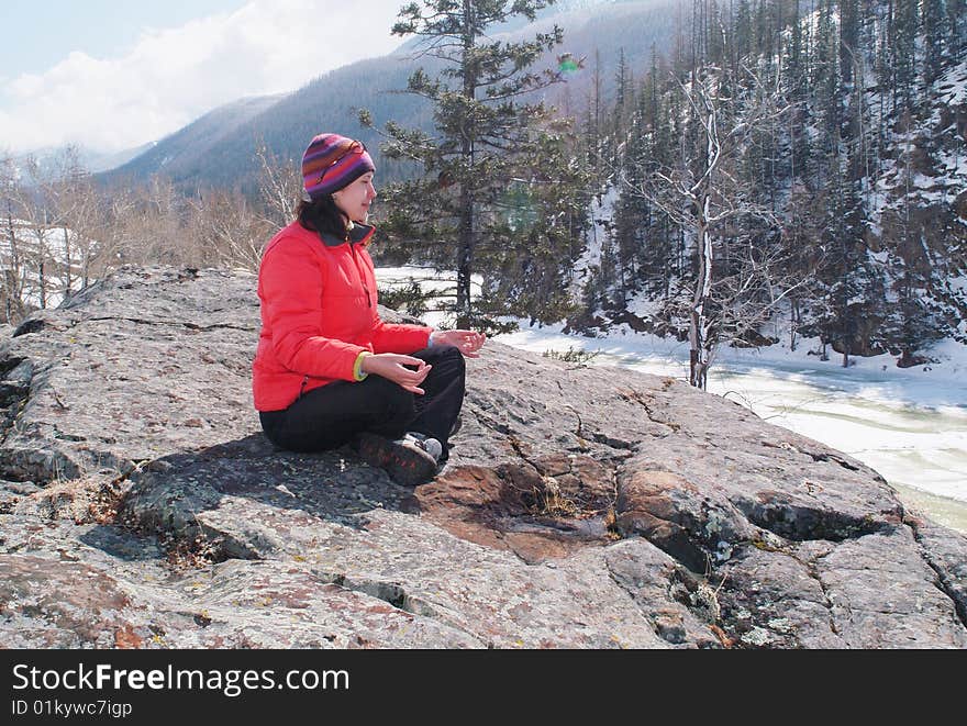 Young women meditating in wilderness 1