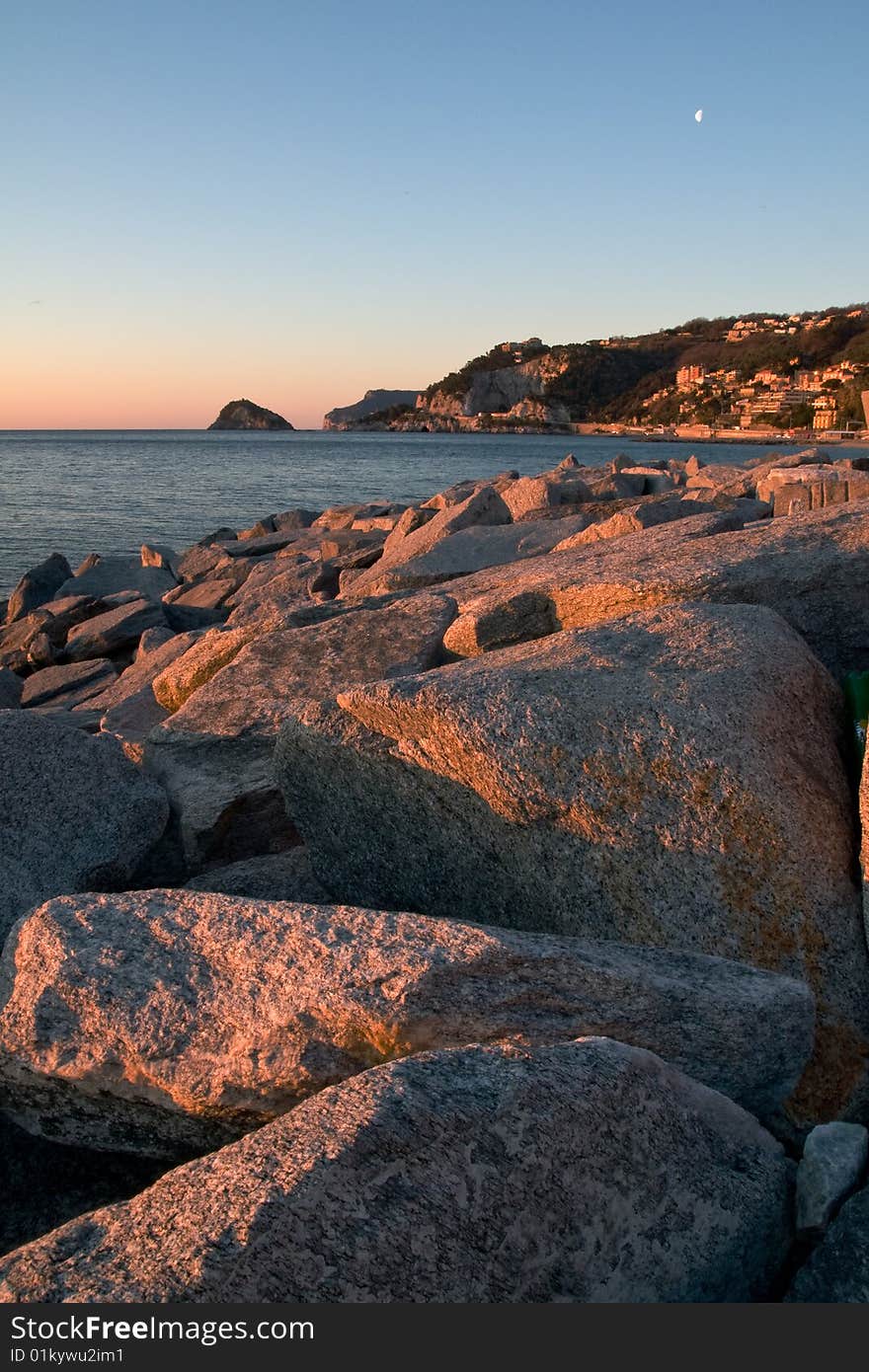 Sunrise reflect on rocks near the sea