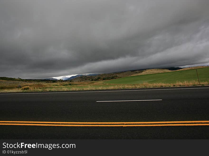 Low dark clouds hanging above hilly landscape in Colorado USA. Low dark clouds hanging above hilly landscape in Colorado USA