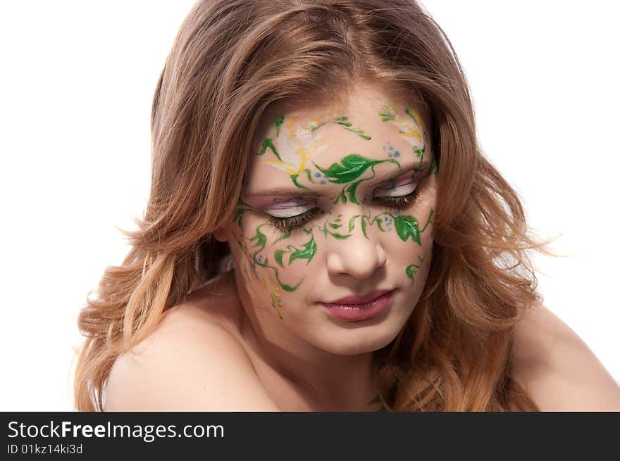 Portrait of a redhear girl witn faceart, looking down