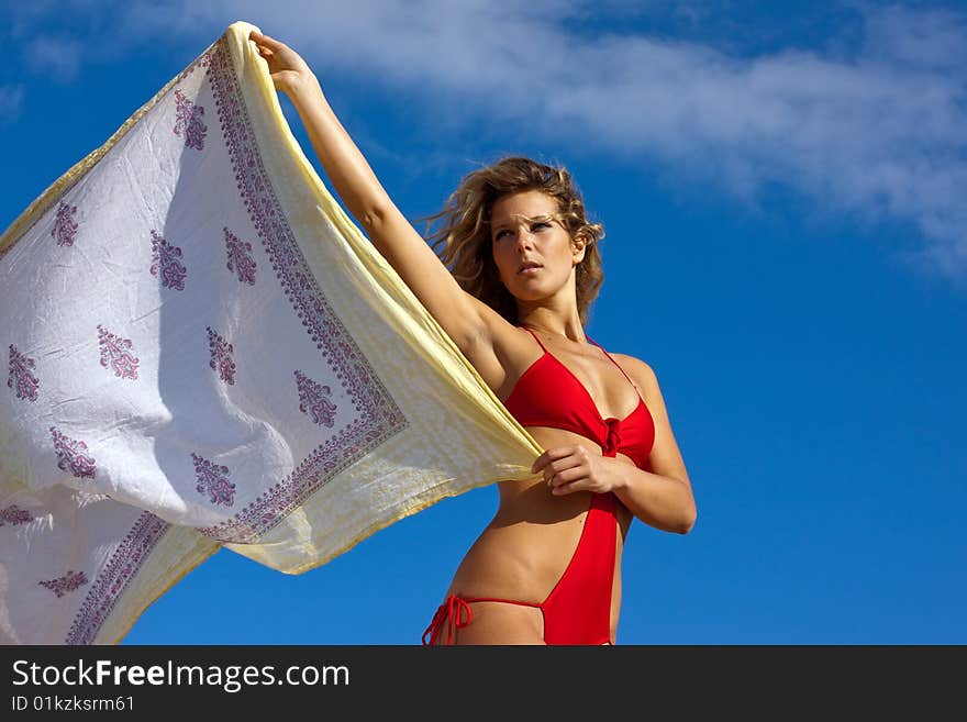 Young beautiful woman with red bikini on the beach. Young beautiful woman with red bikini on the beach