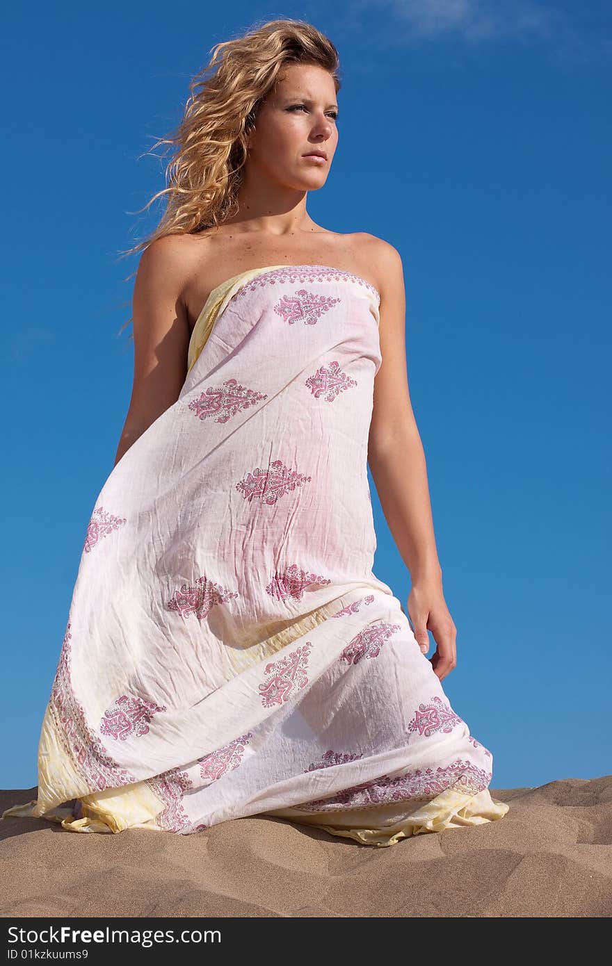 Young beautiful woman with white dress on the beach