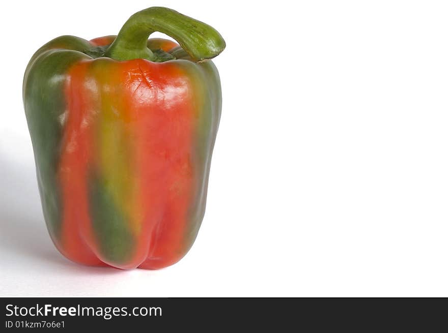 Single multi-colored - green and red pepper on white background. Horizontal image with clipping path and copy-space. Single multi-colored - green and red pepper on white background. Horizontal image with clipping path and copy-space.