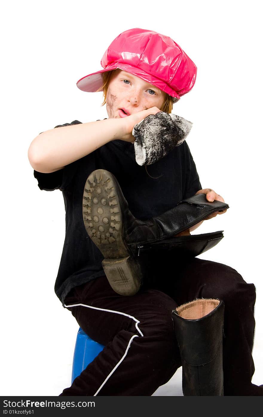 Little bootblack girl is shining up the shoes isolated on white