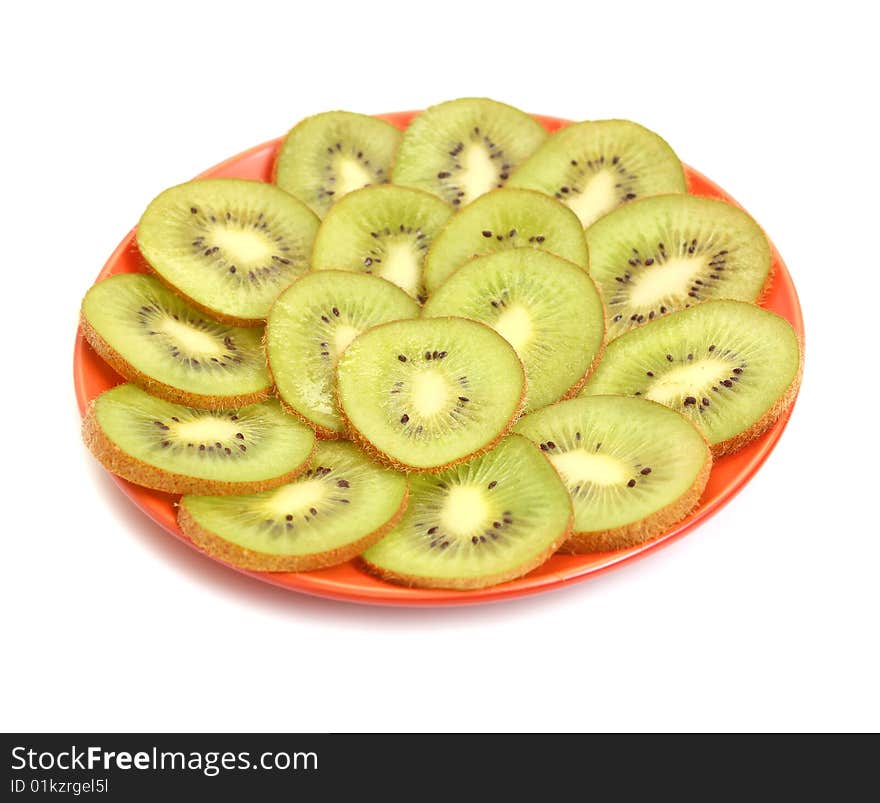 Green kiwi in plate isolated on white background