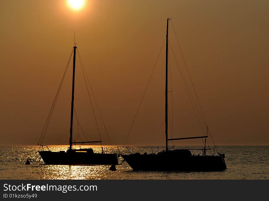 Two boat silhouettes at sunset. Two boat silhouettes at sunset