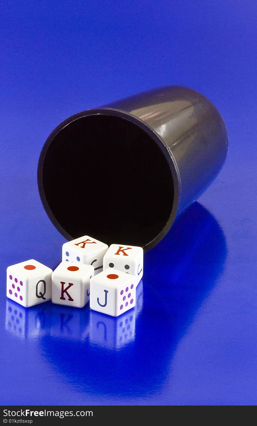 Tumbler with dices in poker on blue background