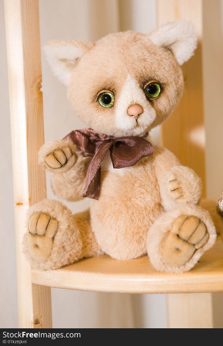 Plush cat doll sitting on a chair