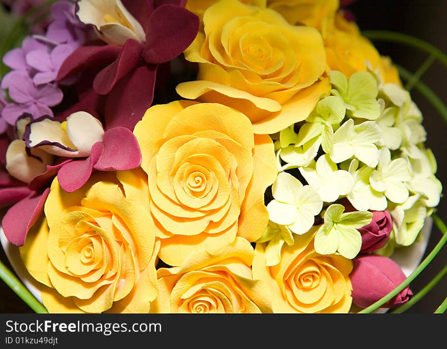 Coloured artificial flowers in basket. Coloured artificial flowers in basket