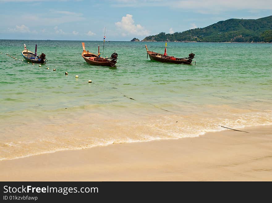 Three wooden boats at the beach