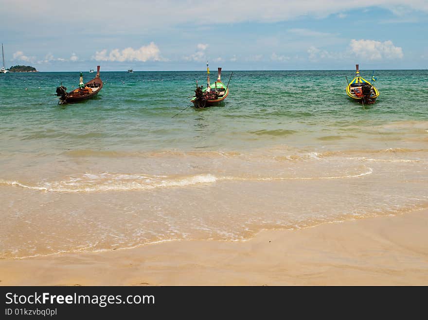 Three wooden boats at the sea, Phuket, Thailand