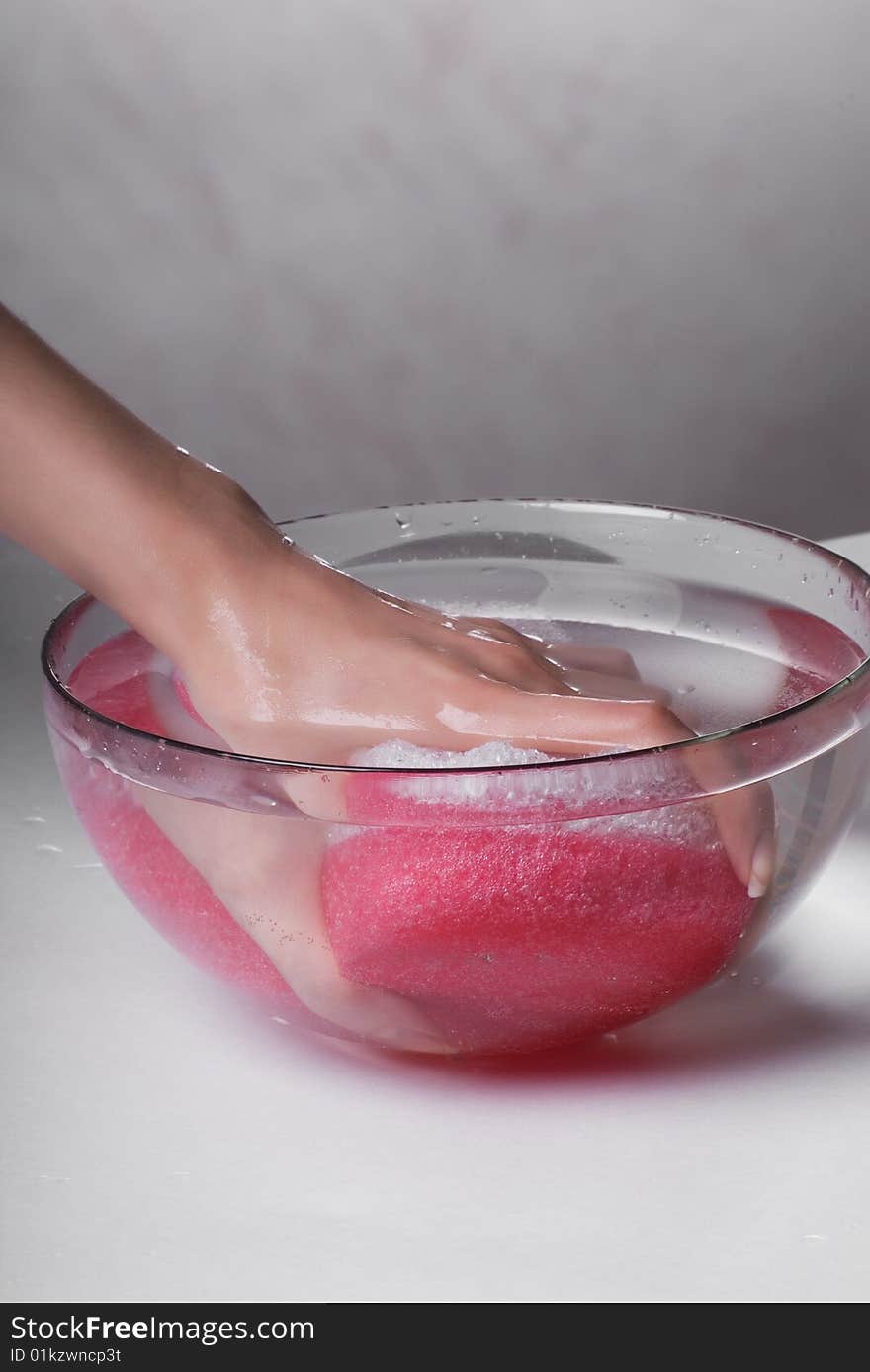 Hand in water and a sponge for washing