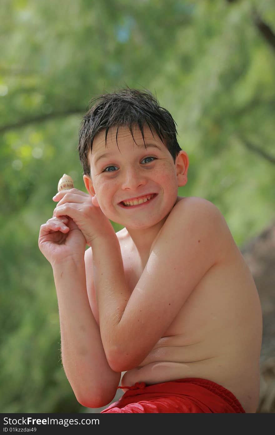 Smiling boy found a shell