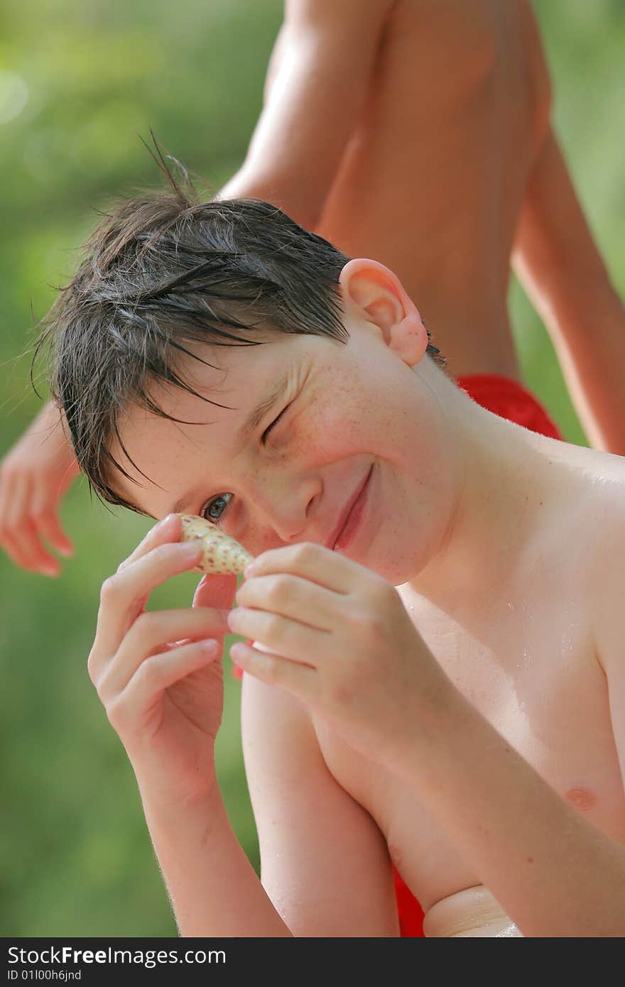 Teenage boy looking at a shell. Teenage boy looking at a shell