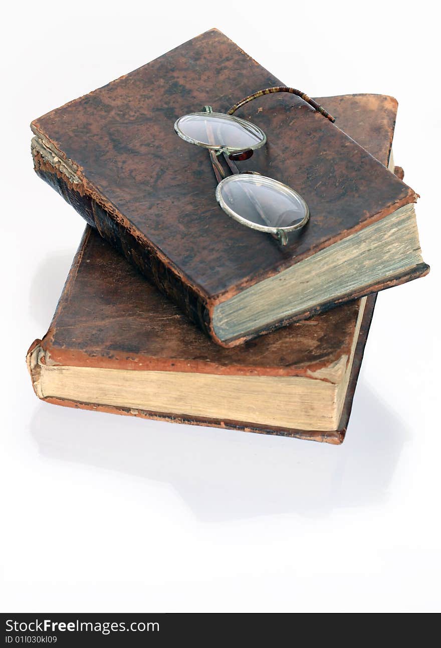 Two antiques books with spectacles isolated on white background. Two antiques books with spectacles isolated on white background