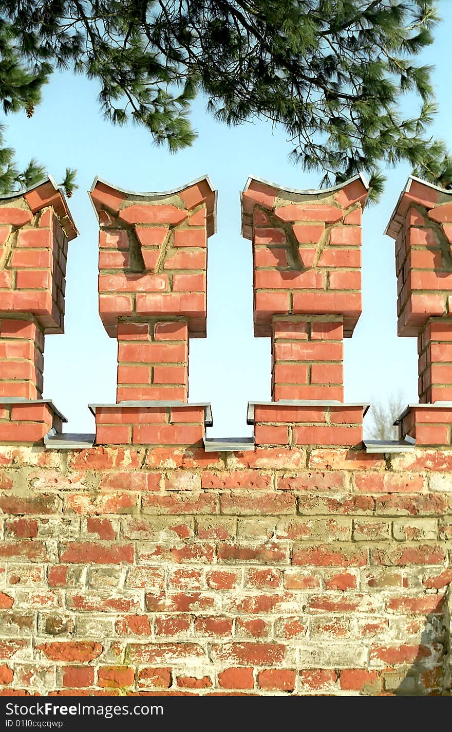 Merlons of red brick wall close up