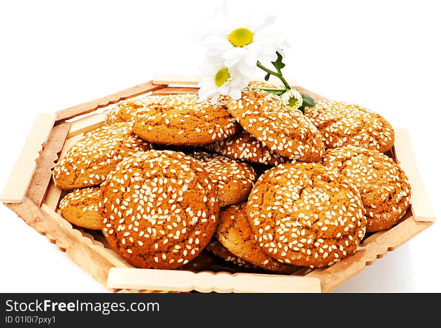 Cookies in wooden vase and chamomile