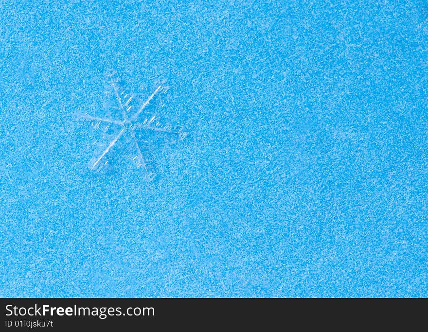 Snowflake on blue macro shot