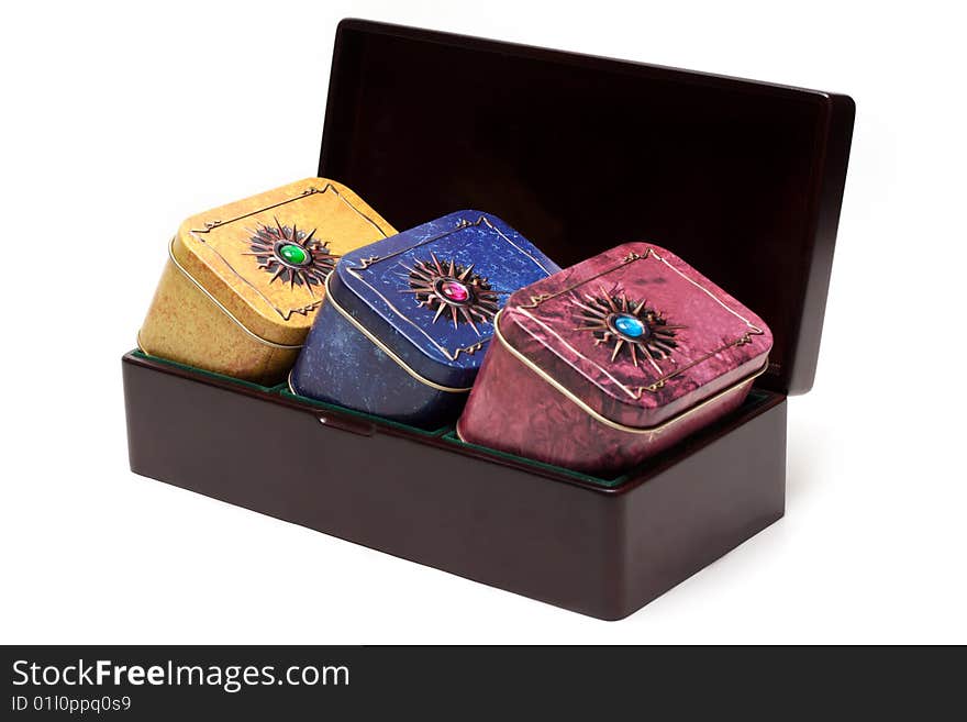 Box with tea, iron packing, decorated stone on white background