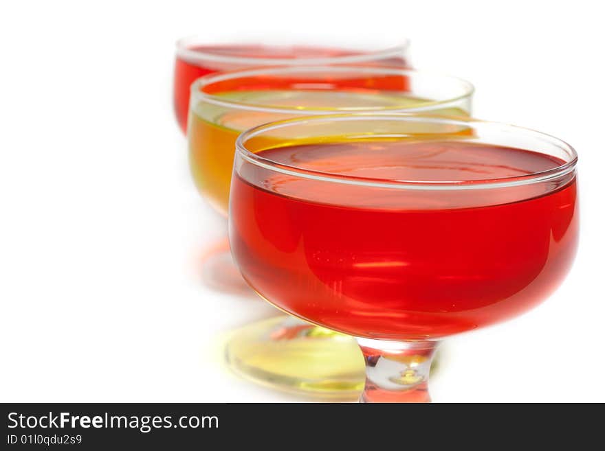 Yellow, red jelly in transparent glass stand on white background inline. Yellow, red jelly in transparent glass stand on white background inline