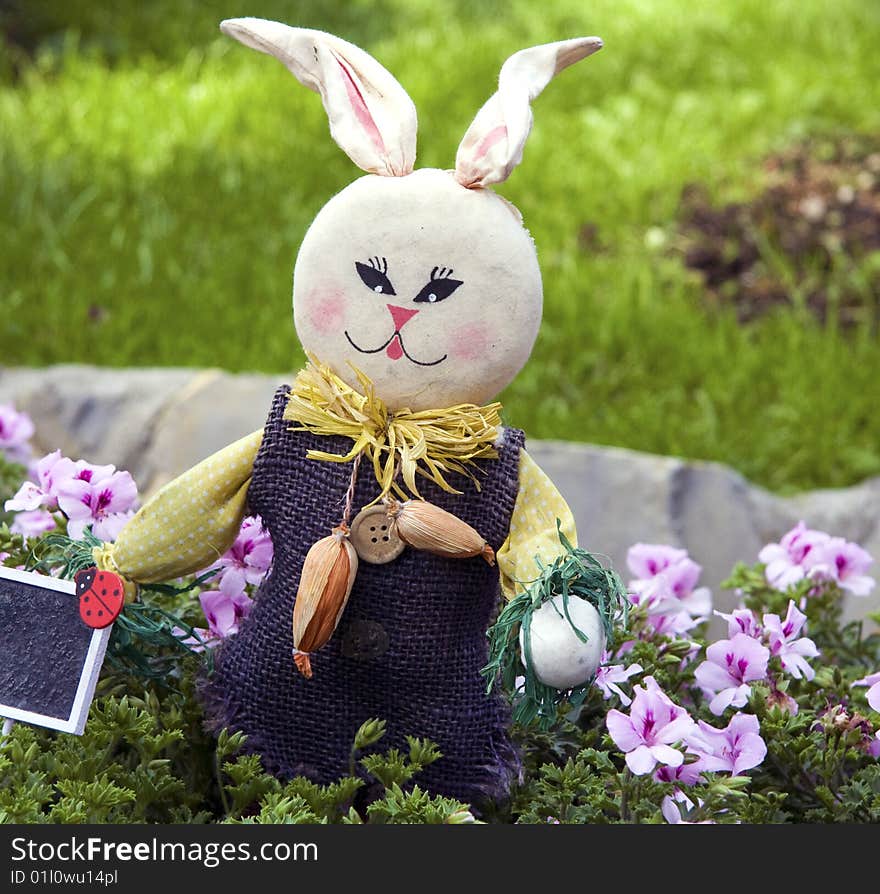 A buonny puppet near the flowers