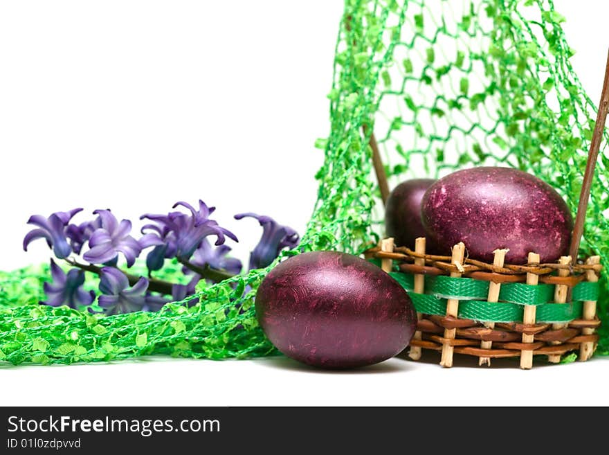 Easter eggs with spring flowers in a basket