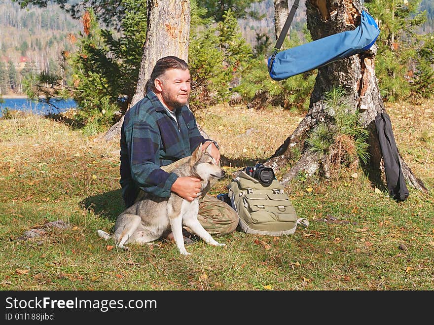 Old men and his hunting dog sitting in nature. Old men and his hunting dog sitting in nature