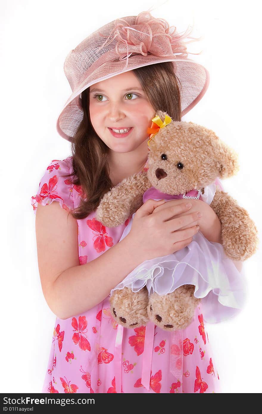 Girl in pink hat and dress with her teddy. Girl in pink hat and dress with her teddy