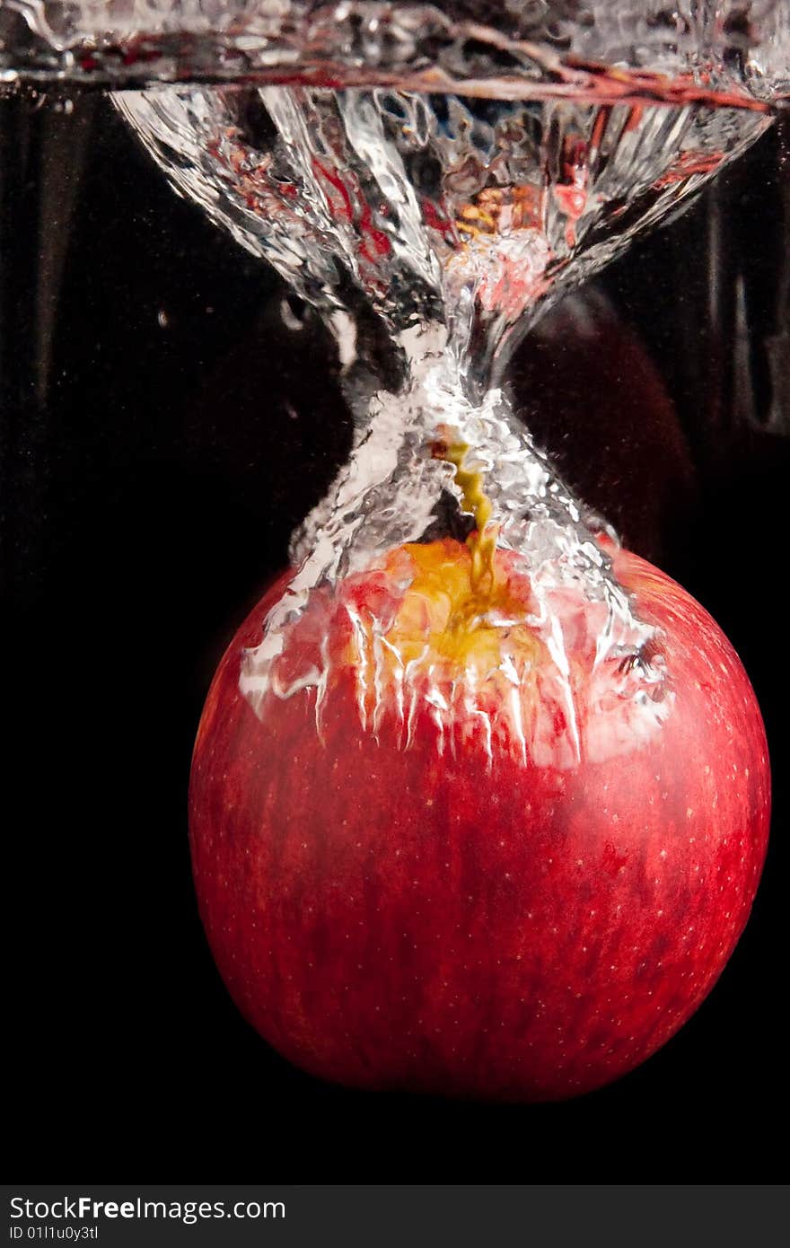 Fresh red apple diving in water. Fresh red apple diving in water