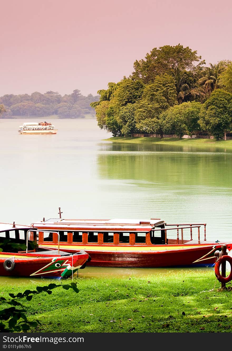 Lakeside with boats parking in green background. Lakeside with boats parking in green background